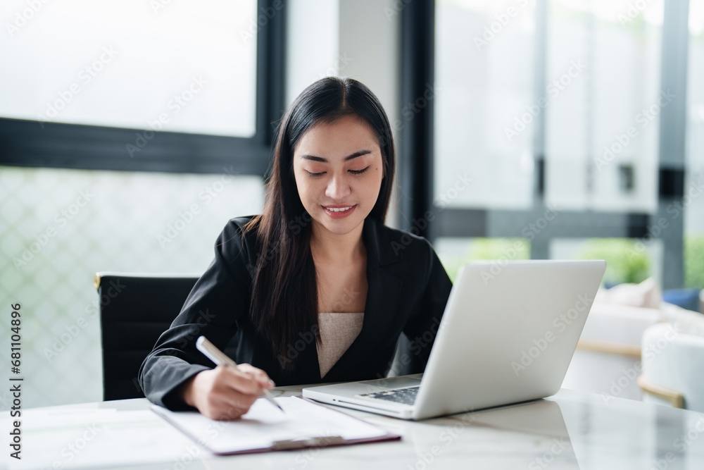 Portrait of asian woman working on desk at contemporary corporation office. Portrait of asian woman working on desk at contemporary corporation office.