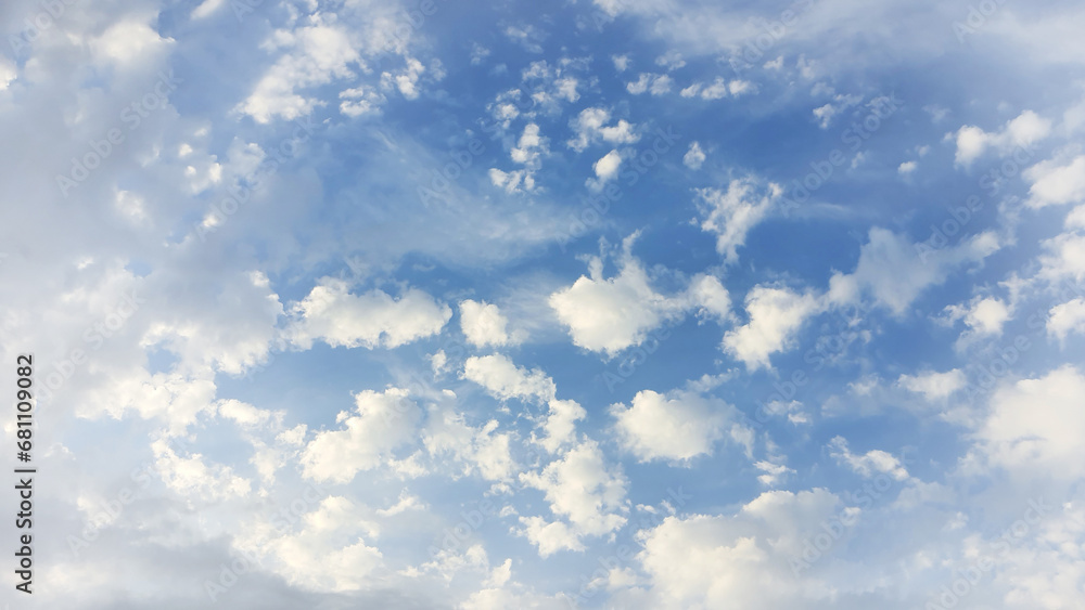 Scattered cumulus clouds against a blue sky, sunlight filtering through. Scattered cumulus clouds against a blue sky, sunlight filtering through.
