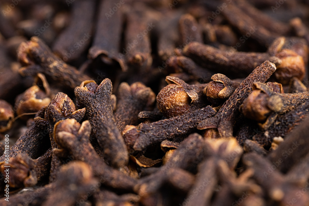 Freshly dryed clove spice texture close up. Cloves spread on the ground. Clove is a dried herb for food flavor and natural medicine. Dry Organic Clove Spice Freshly dryed clove spice texture close up. Cloves spread on the ground. Clove is a dried herb for food flavor and natural medicine. Dry Organic Clove Spice