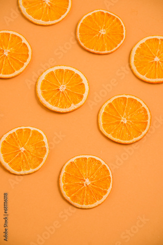 Dried orange circles on a bright light background. View from above