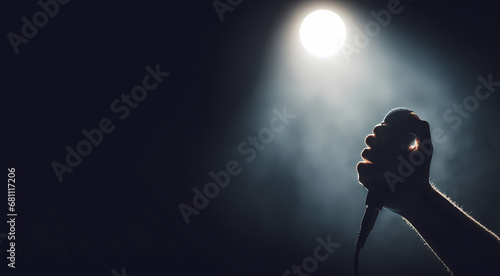 Handheld microphone with stage lighting background , banner has space for typing text