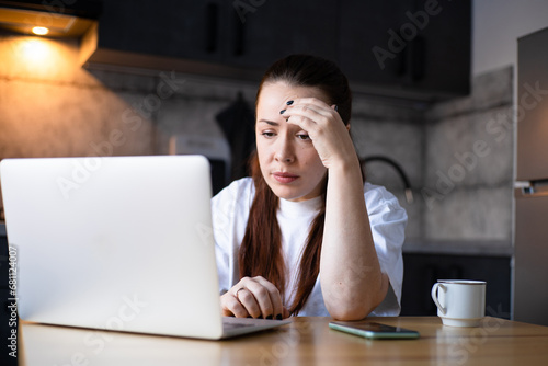 Close up unhappy stressed businesswoman reading bad news in email, frustrated student working on difficult task, online project. Hard remote work. Work on the kitchen office