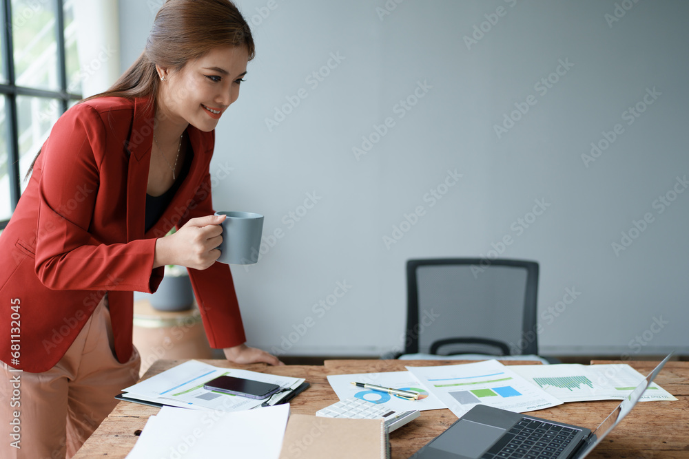 Businesswoman enjoys relaxing with a cup of coffee after a long day. Businesswoman enjoys relaxing with a cup of coffee after a long day.