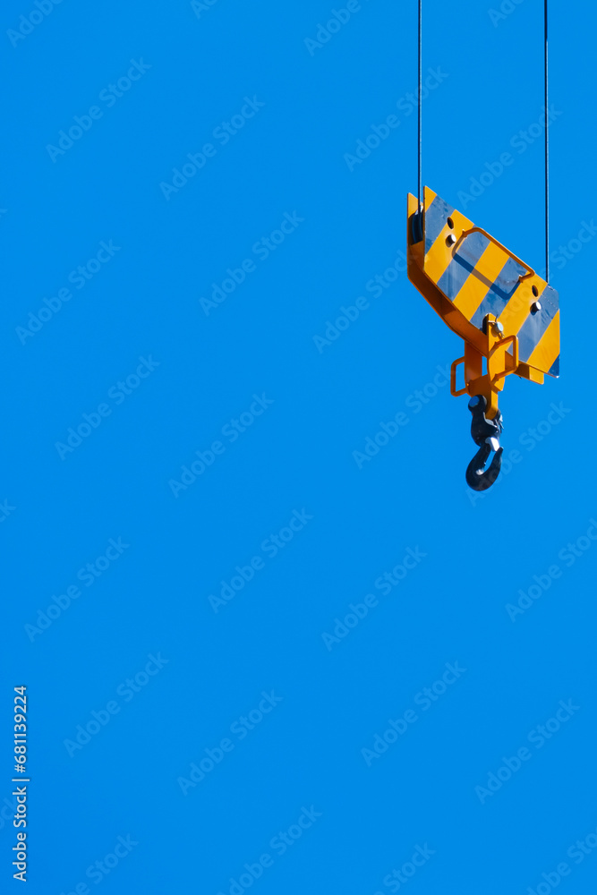 The yellow hook of a crane on a blue sky background.
Personal growth concept. The yellow hook of a crane on a blue sky background.
Personal growth concept.