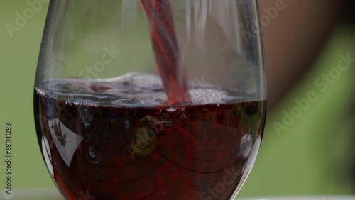 Bottom-to-top detailed close-up view of a wine glass being filled with rich red wine, lifted for a sip, and gently placed back on the table — perfect for luxury, lifestyle, dining, and celebration the