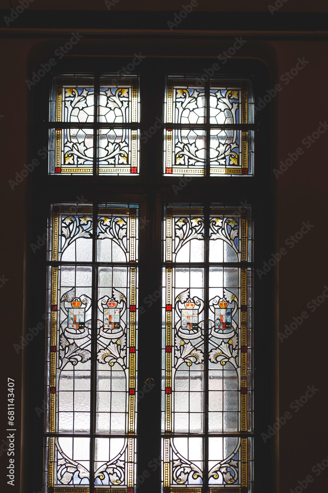 A Vibrant Stained Glass Window Illuminating a Mysterious, Enchanting Room at Peles Castle