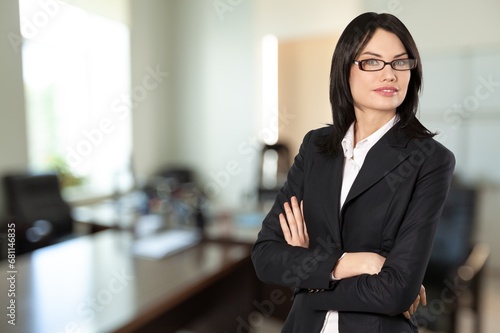 Young happy smart businesswoman in office