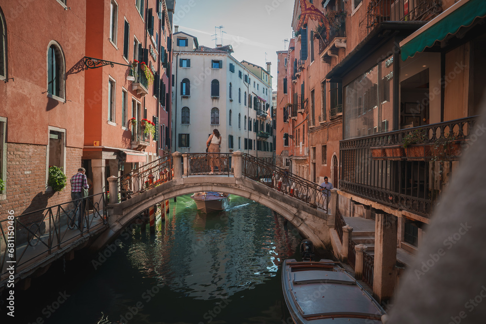 A scenic view of a canal in Venice, Italy, showcasing the vibrant atmosphere and typical activities such as water transportation, sightseeing, and dining.