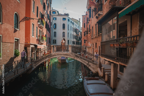 A scenic view of a canal in Venice, Italy, showcasing the vibrant atmosphere and typical activities such as water transportation, sightseeing, and dining.