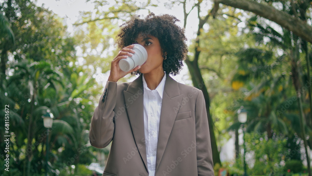 Business lady going park alley with coffee closeup. Girl walking looking phone. Business lady going park alley with coffee closeup. Girl walking looking phone.