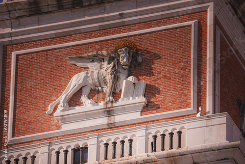 The winged lion sculpture-venetian symbol on St Marks Campanile facade- Campanile di San Marco-bell tower of St Marks Basilica in Venice, Italy, one of the most recognizable symbols of the ciy photo
