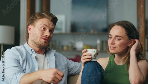 Talking duet drinking tea at sofa interior closeup. Calm woman sipping coffee photo