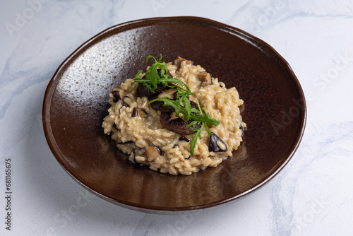 Risotto with mushrooms on a white background.
