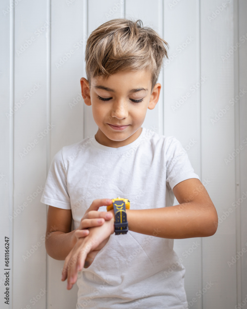 caucasian boy 7 years old male child kid use smart watch at home caucasian boy 7 years old male child kid use smart watch at home