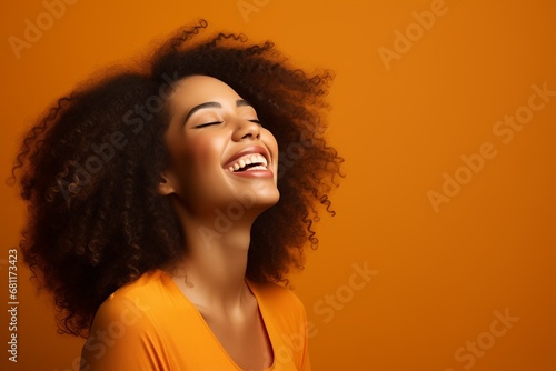 Beautiful gorgeous african american young woman model woman with afro hair laughing and smiling. Young Black woman close up portrait. Healthy face skin care beauty, skincare cosmetics, dental.