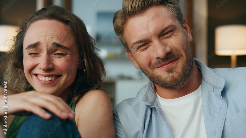 Obraz premium Laughing couple watching comedy at home pov. Joyful people reacting emotionally