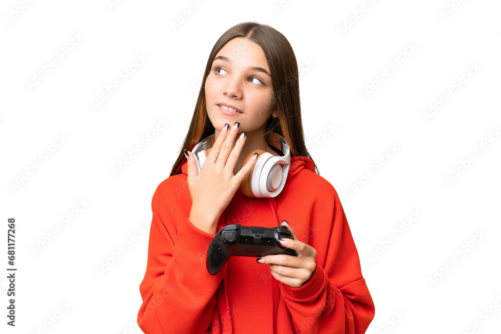 Teenager caucasian girl playing with a video game controller over isolated background looking up while smiling Teenager caucasian girl playing with a video game controller over isolated background looking up while smiling