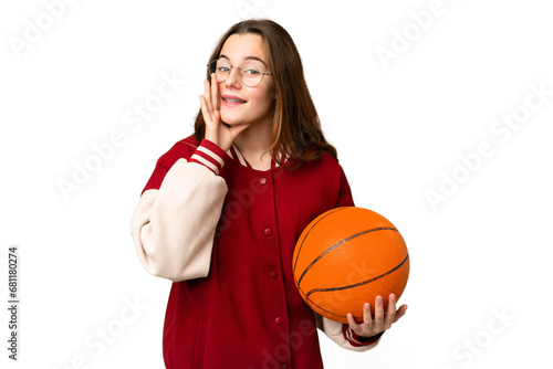 Teenager girl playing basketball over isolated chroma key background shouting with mouth wide open © luismolinero