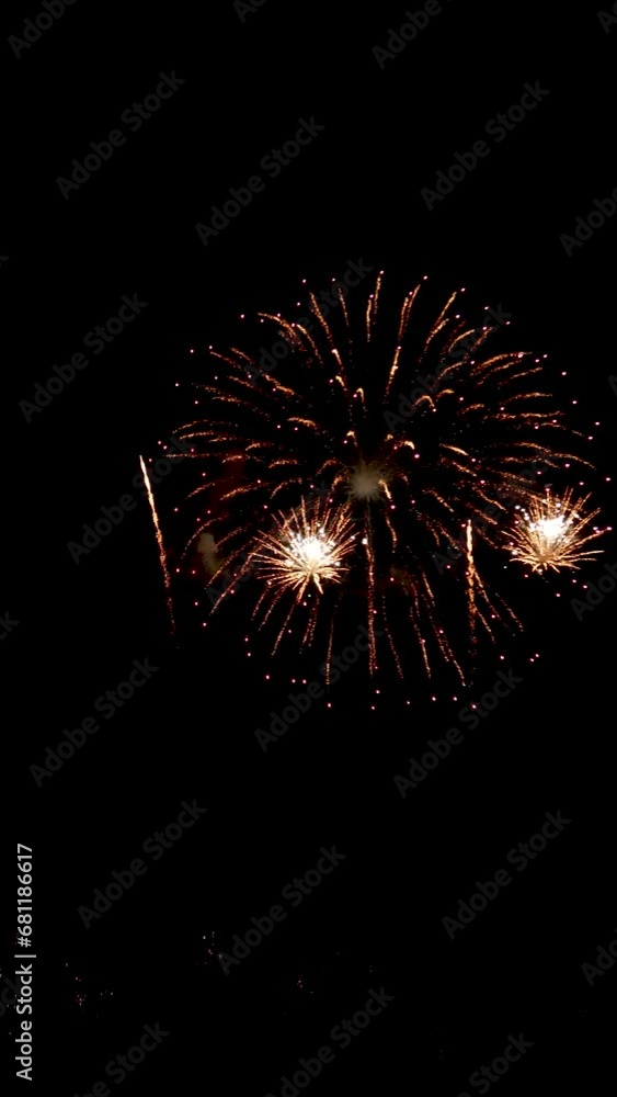 4K vertical. seamless looping of real beautiful fireworks background during new year's eve countdown celebration, real golden shining firework festival in the sky at night with colorful.