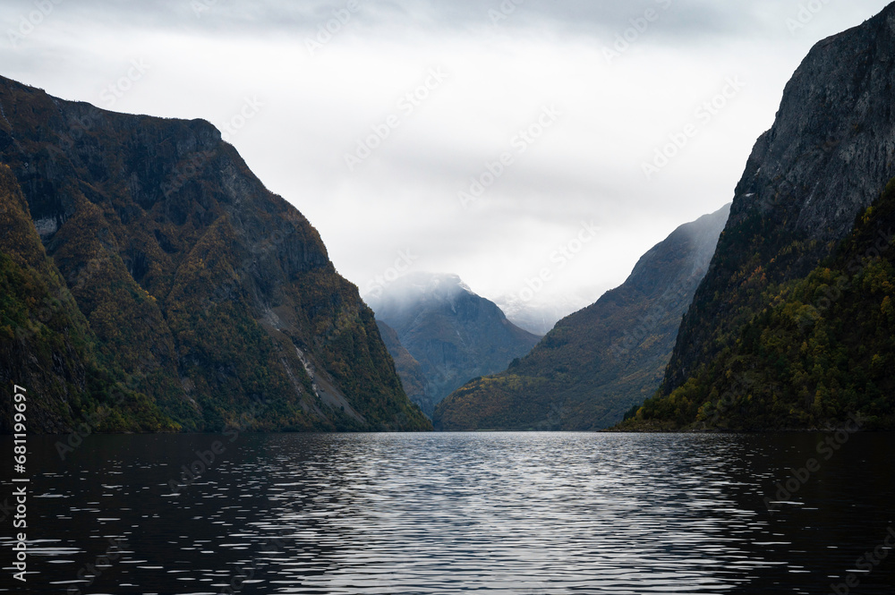 Panoramic image of the fjords of Norway in autumn, at sunset, with gloomy darkness in the air.
