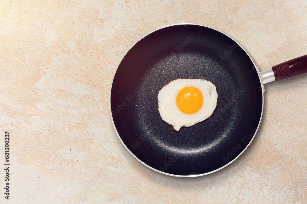 Tasty fried egg on pan on the desk Tasty fried egg on pan on the desk