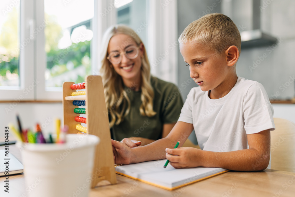 Cute Caucasian preschooler is learning counting with abacus. Cute Caucasian preschooler is learning counting with abacus.
