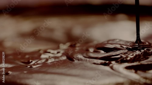 Slow motion of pouring dark hot chocolate. photo