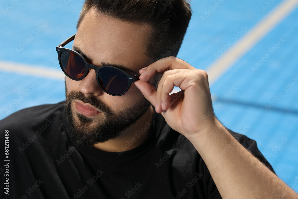 Handsome man in sunglasses outdoors, space for text Handsome man in sunglasses outdoors, space for text