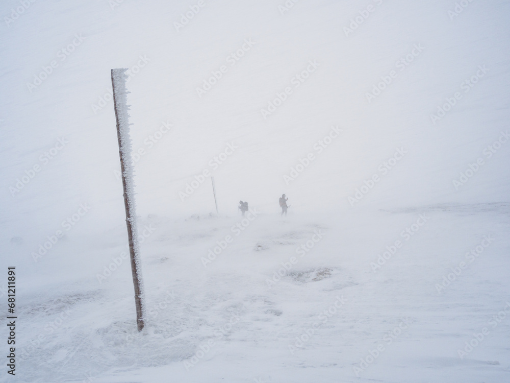 Two tourists on a hiking trail in a snowstorm. Two tourists on a hiking trail in a snowstorm.