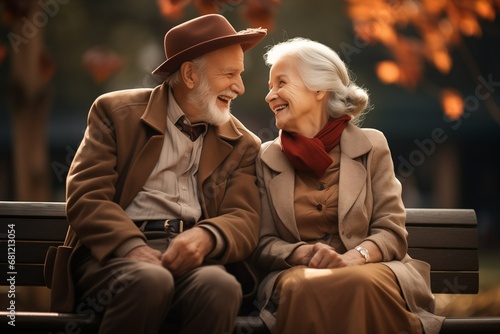 Happy Cheerful senior couple sitting on a bench in public park together having fun lifestyle. Perfect activities for elderly people. Happy mature couple in park at fall. Generative AI photo