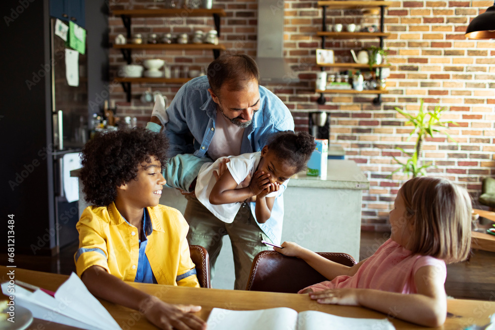 Joyful Multiethnic Family Enjoying Time Together at Home Joyful Multiethnic Family Enjoying Time Together at Home