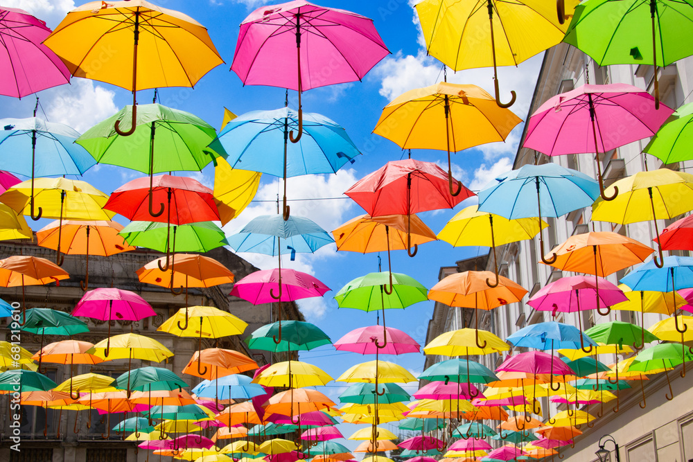 Multicolored umbrellas against a blue sky