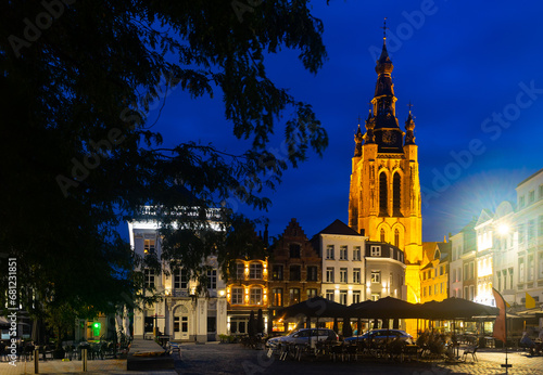 Evening central Grote Markt square with a view of the bell tower of St. Martin Church in Kortrijk, Belgium