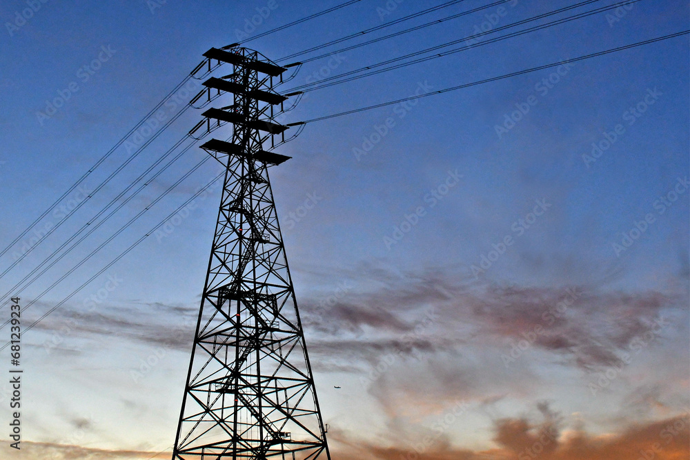 Silhouette of four tier power transmission tower Silhouette of four tier power transmission tower