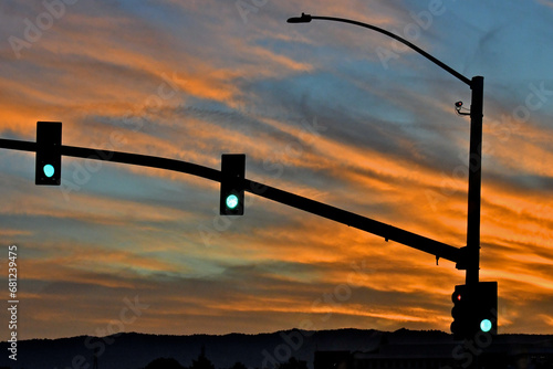 Fotografi Green signal lights and colorful sunset