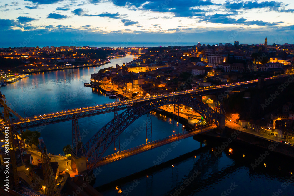 Panoramic view of illuminated Porto cityscape and Ponte Dom Luis I over river Douro at night, Portugal..