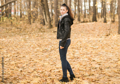 Outdoor atmospheric lifestyle portrait of young beautiful young woman copy space. Warm autumn fall season. Millennial generation and youth