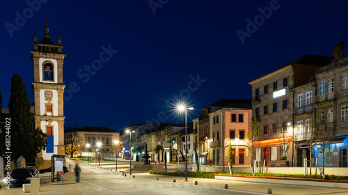 Scenic night view of landscaped Carvalho Araujo Avenue in Portuguese city of Vila Real overlooking bell tower of S. Domingos Convent Church in spring photo