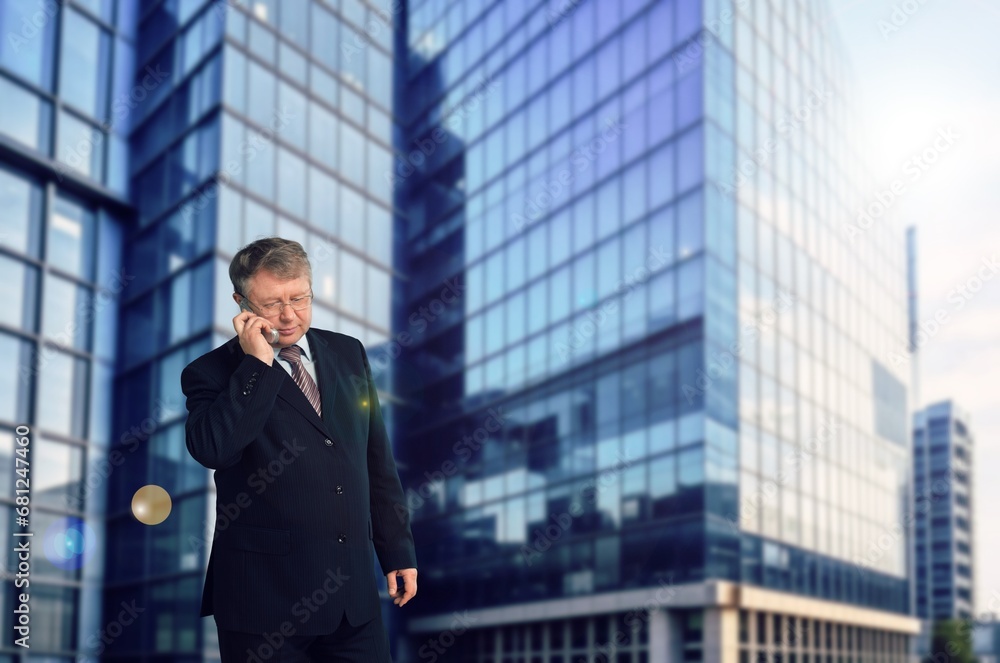 Young happy businessman standing in city street Young happy businessman standing in city street
