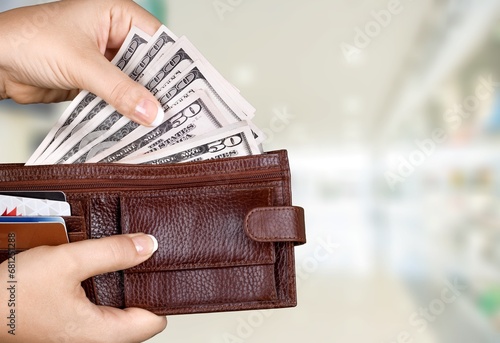 hand taking money notes out of wallet
