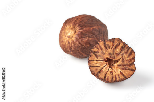 Two dried nutmegs isolated on white background