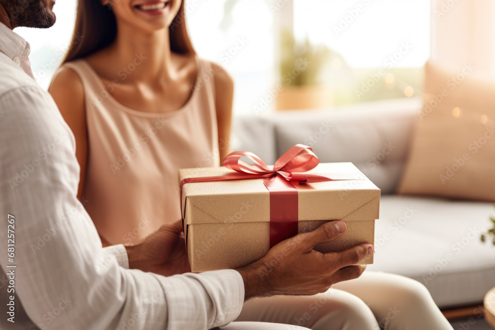 Man and woman in love exchange a gift - obrazy, fototapety, plakaty 