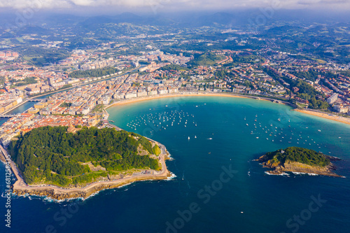 Picturesque aerial view of turquois water of La Concha Bay of San Sebastian with Santa Clara Island and moored pleasure yachts, Spain..