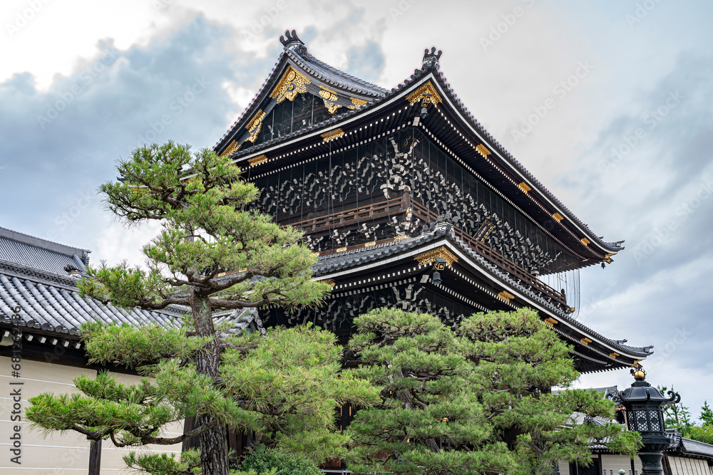 Low angle perspective on the majestic temple in Kyoto, Japan called Higashi Honganji.
Artistic view with surrounding trees.
