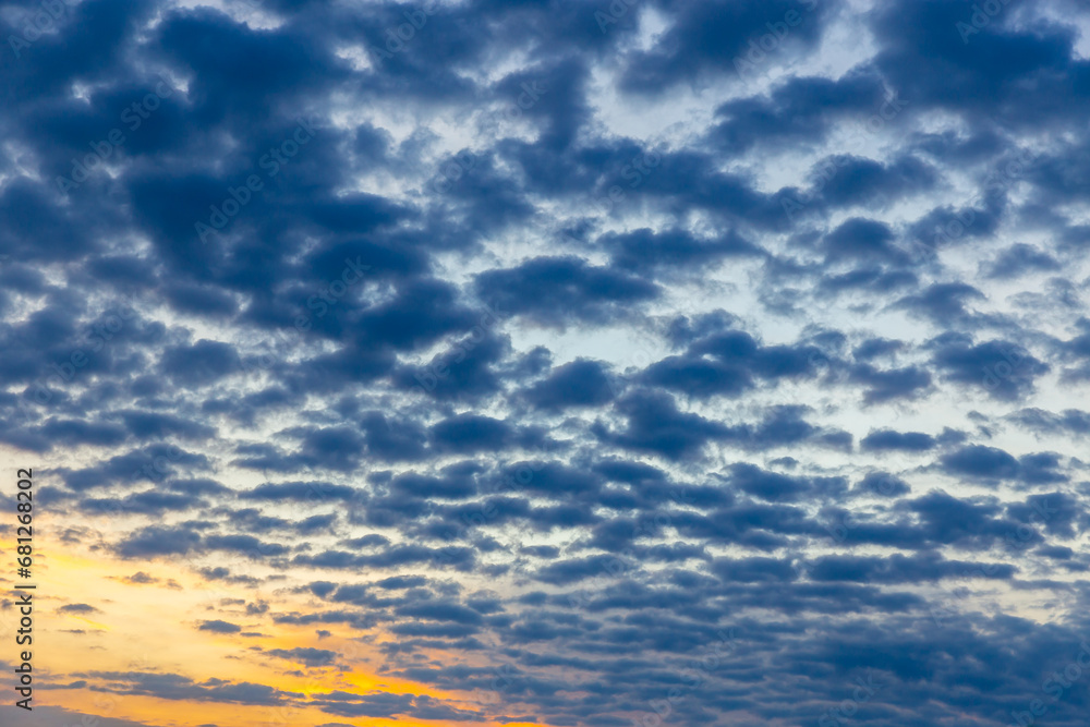 Fototapeta premium Wonderful idyllic sky with gray clouds and orange tones