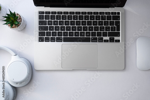 Laptop computer with a headphones and mouse from above