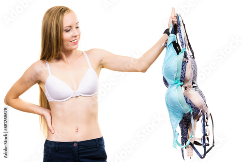 Woman holds bras, choosing