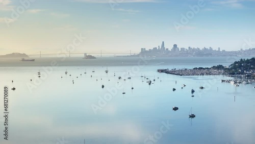 Panoramic view of Golden Gate Bridge and San Francisco city in morning light, California, USA. Drone shot of yachts floating in Pacific ocean. City buildings looking in the distance, 4k footage  photo