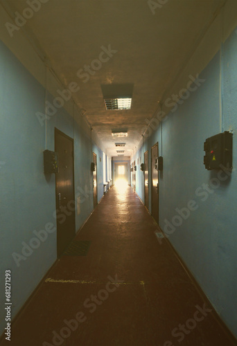 The gloomy corridor of a neglected public building. Public space in a poor residential high-rise building