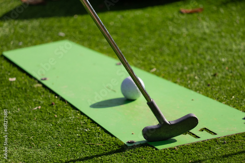 golf club and ball on green, mini golf